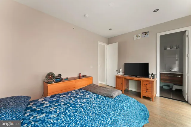a bedroom with a bed and a flat screen tv