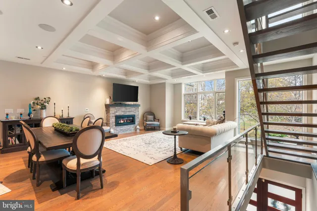 a living room with furniture a flat screen tv and a large window