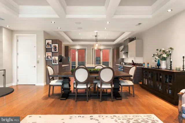 a room with wooden floors dining table and chairs