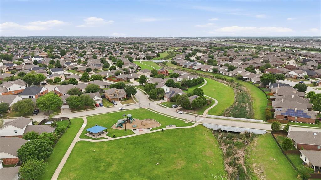 11500 Starlight Ranch Fort Worth, TX 76052 - Photo 40 of 40 An aerial view showcasing a well-maintained neighborhood with numerous residential properties, green spaces, and a community park