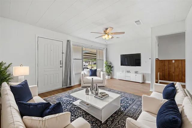 a living room with furniture and a flat screen tv