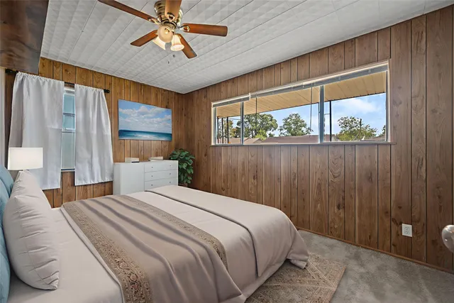 a bedroom with a large bed and a chandelier