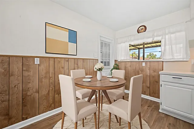 a view of a dining room with furniture and window