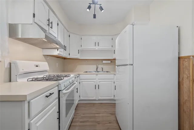 a kitchen with cabinets a sink and appliances