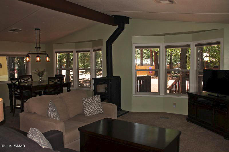 5472 North Blue Ridge Loop Pinetop, AZ 85935 - Photo 5 of 22 a living room with furniture and a flat screen tv