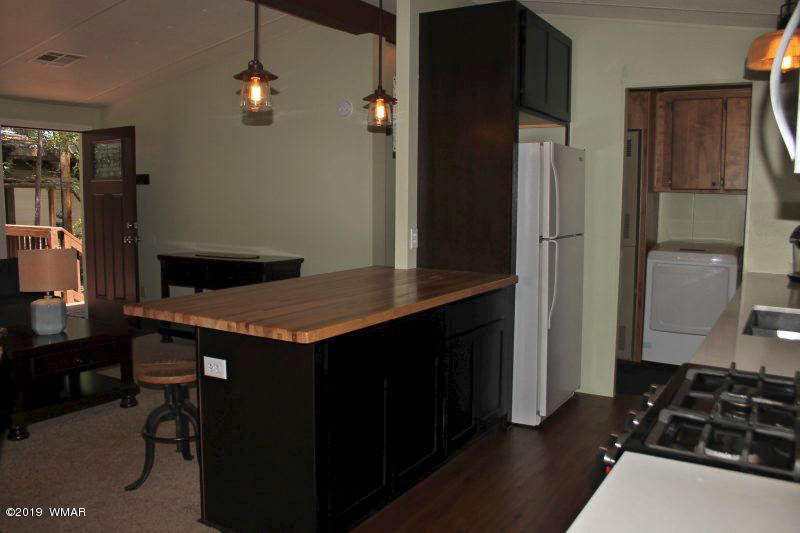 5472 North Blue Ridge Loop Pinetop, AZ 85935 - Photo 10 of 22 a kitchen with a refrigerator and a stove