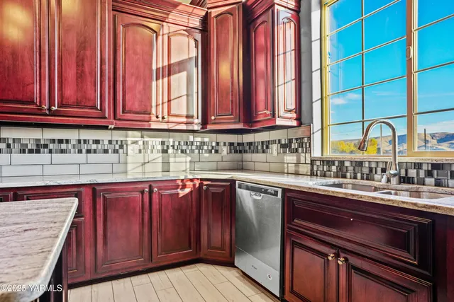 a kitchen with stainless steel appliances granite countertop a stove and cabinets