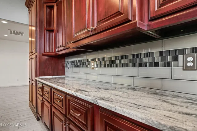 a kitchen with stainless steel appliances granite countertop a stove microwave and sink