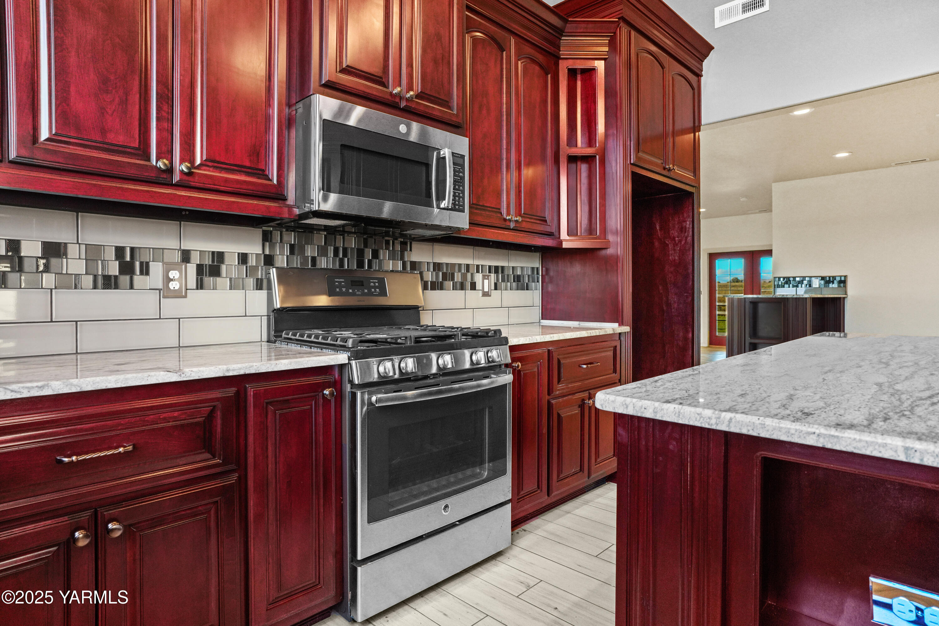 10002 North Wamba Road Prosser, WA 99350 - Photo 15 of 40 a kitchen with stainless steel appliances granite countertop a stove microwave and sink
