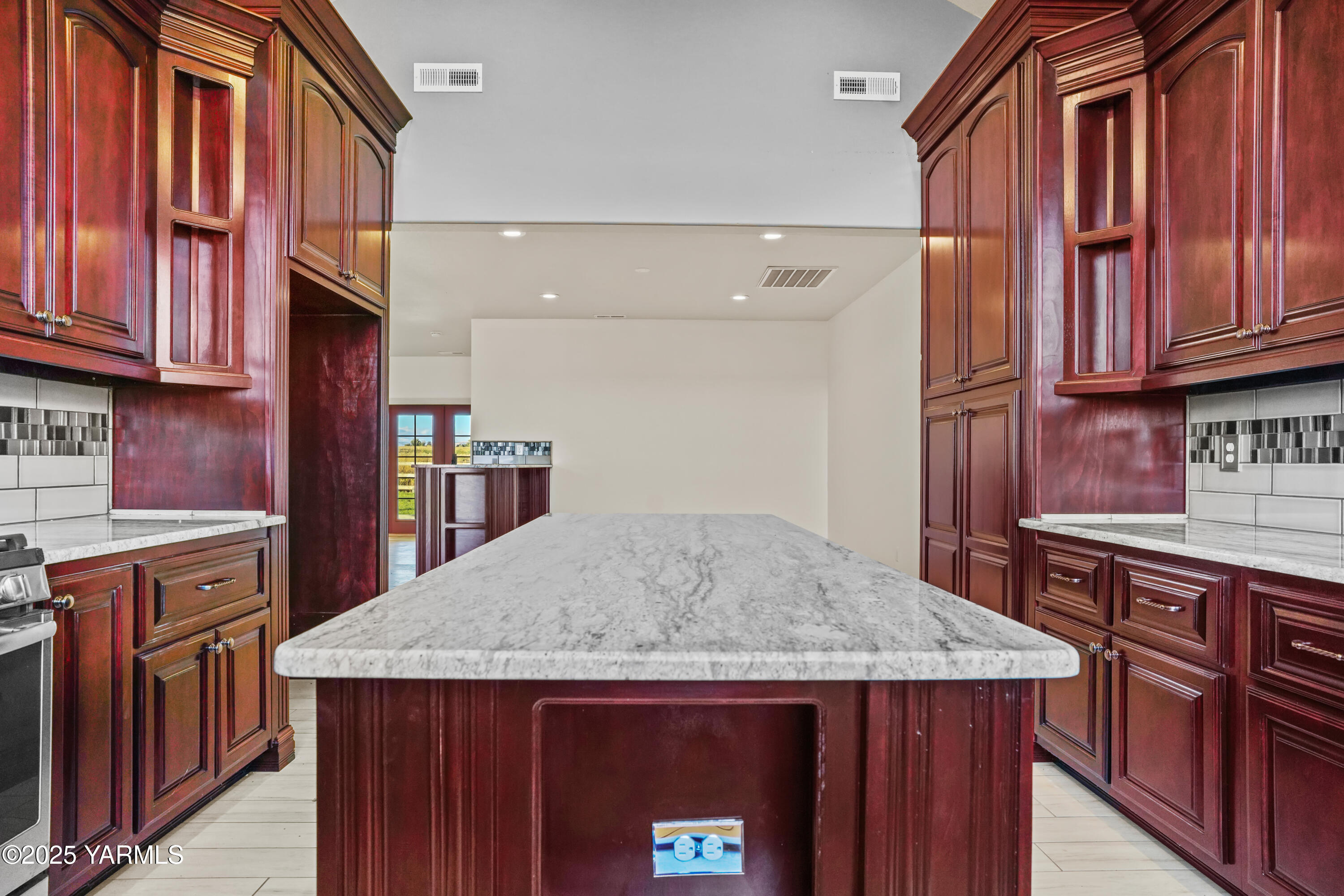 10002 North Wamba Road Prosser, WA 99350 - Photo 16 of 40 a kitchen with stainless steel appliances granite countertop a kitchen island a cabinets a stove and a refrigerator