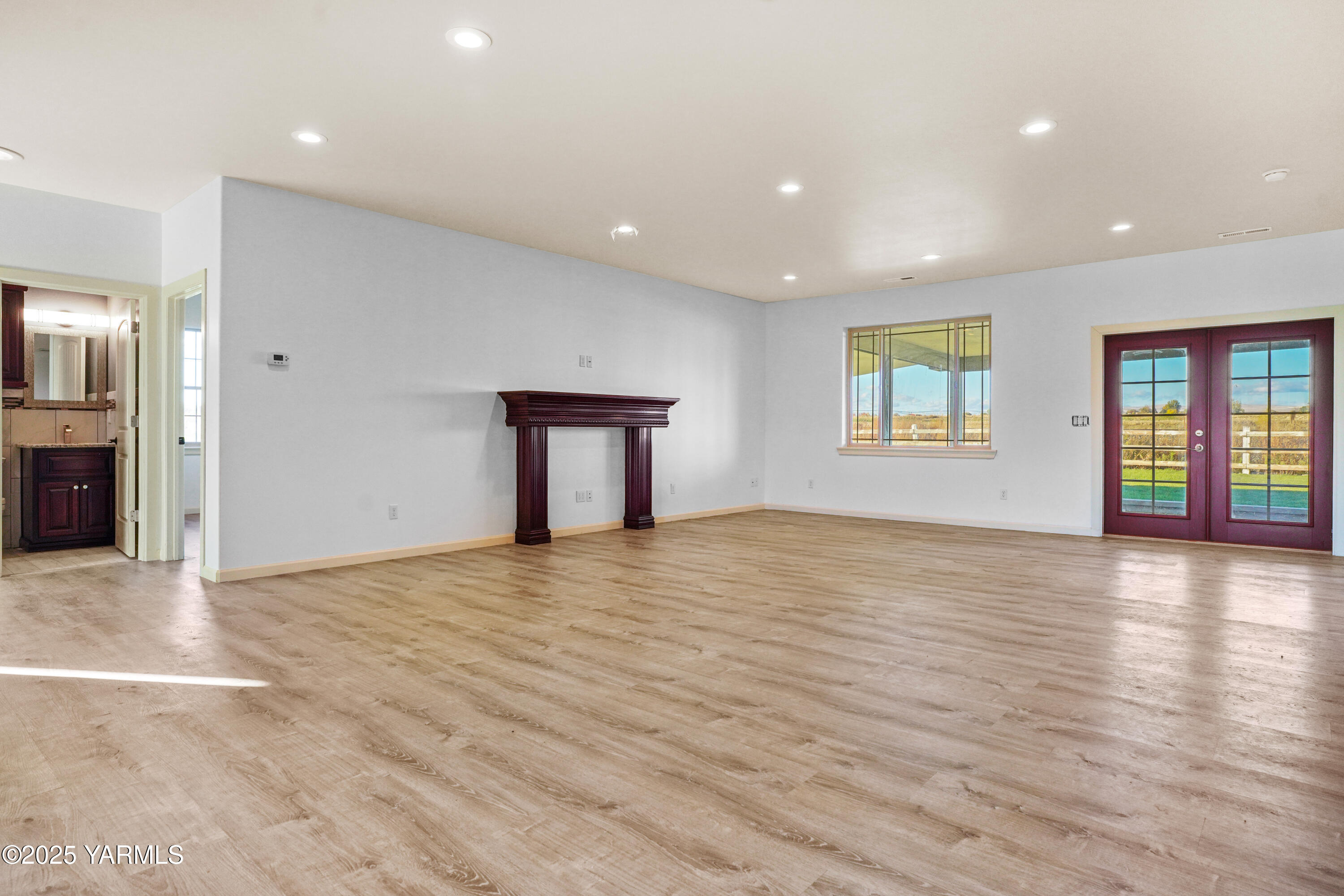 10002 North Wamba Road Prosser, WA 99350 - Photo 8 of 40 an empty room with wooden floor and windows