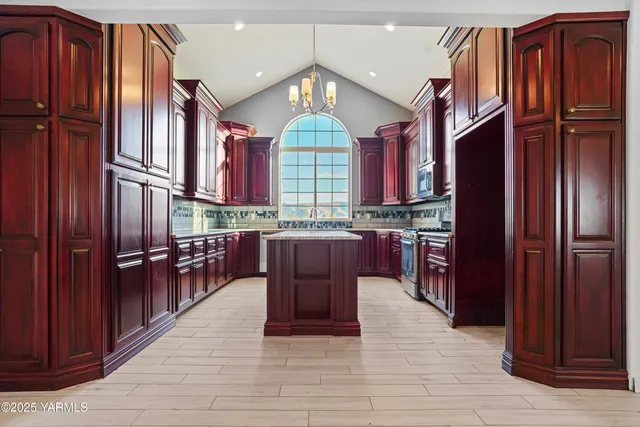 a kitchen with stainless steel appliances granite countertop a sink and cabinets