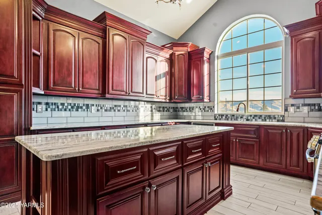 a kitchen with stainless steel appliances granite countertop a stove a sink dishwasher and a wooden cabinets