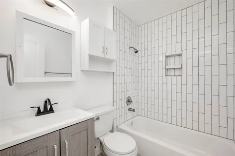 a bathroom with a sink toilet and tub