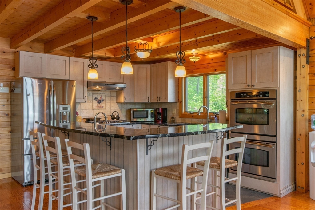 44 3rd Street Brimfield, MA 01010 - Photo 18 of 42 a kitchen with stainless steel appliances granite countertop a stove and a refrigerator