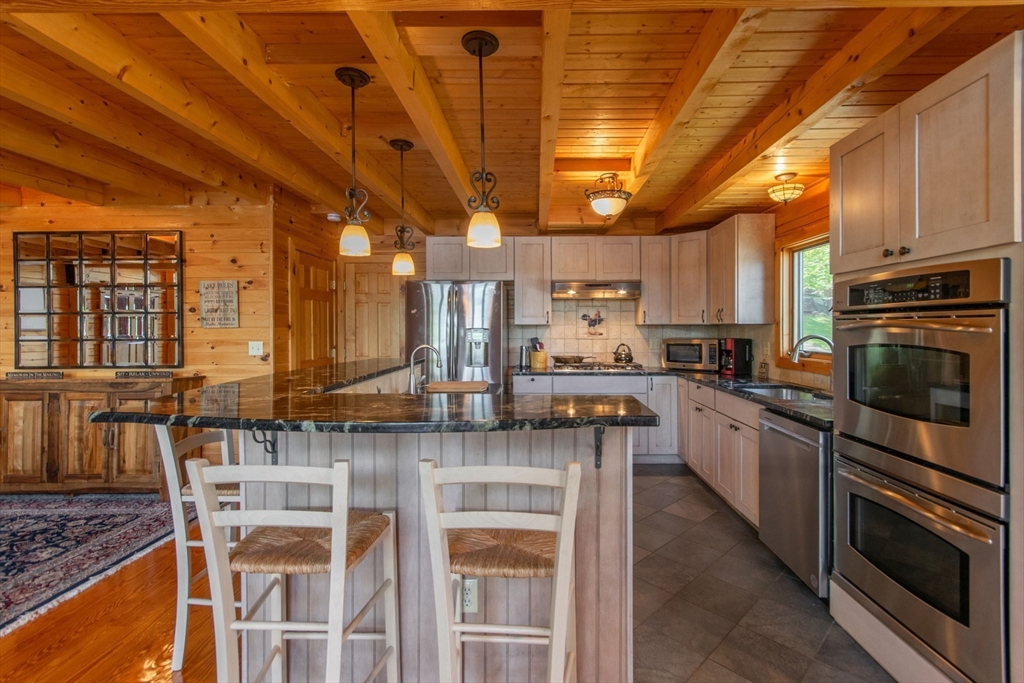 44 3rd Street Brimfield, MA 01010 - Photo 19 of 42 a kitchen with stainless steel appliances granite countertop a stove a sink and a microwave