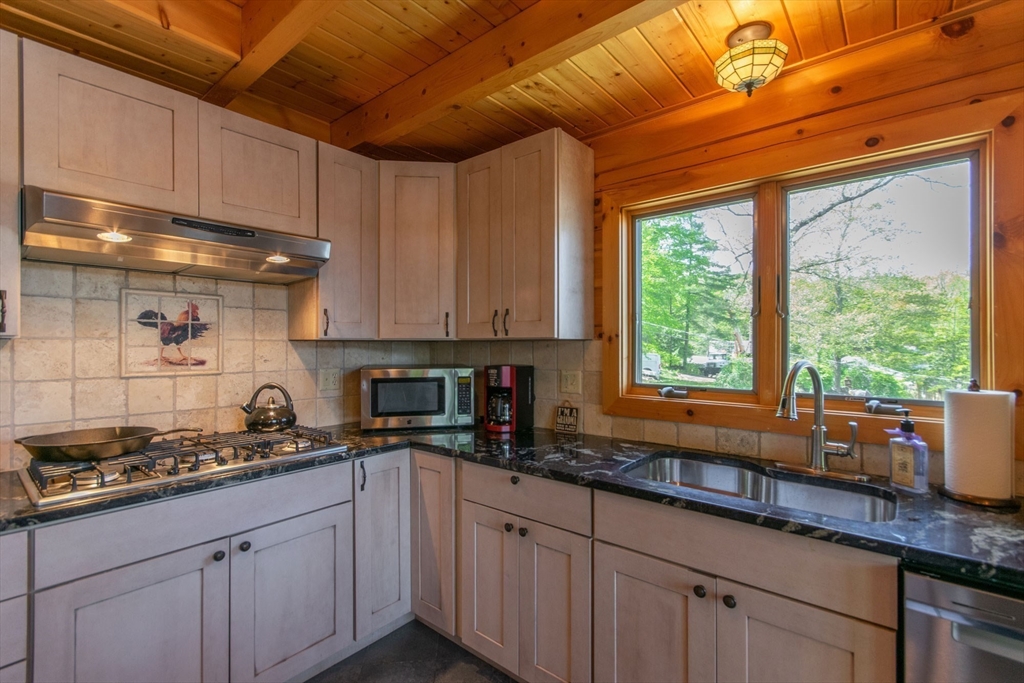 44 3rd Street Brimfield, MA 01010 - Photo 20 of 42 a kitchen with granite countertop a sink a counter space cabinetry and a window