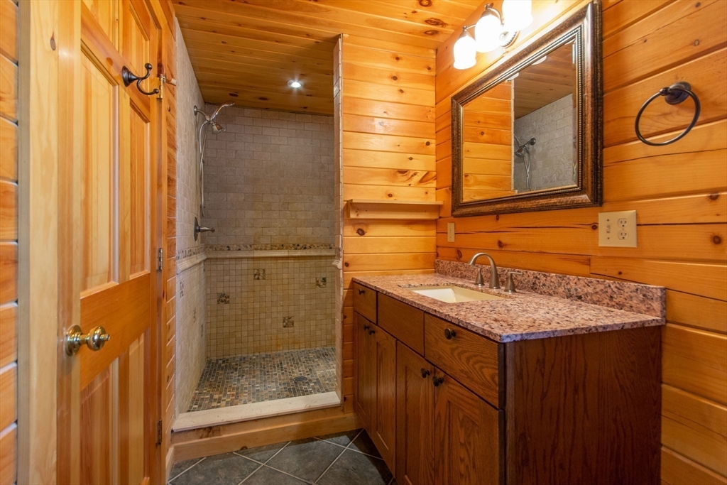 44 3rd Street Brimfield, MA 01010 - Photo 24 of 42 a bathroom with a granite countertop shower and a sink