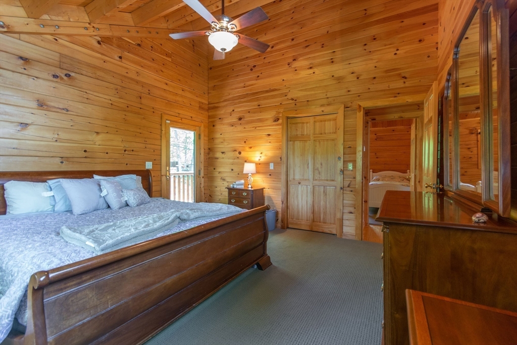 44 3rd Street Brimfield, MA 01010 - Photo 31 of 42 a spacious bedroom with a bed and a chandelier