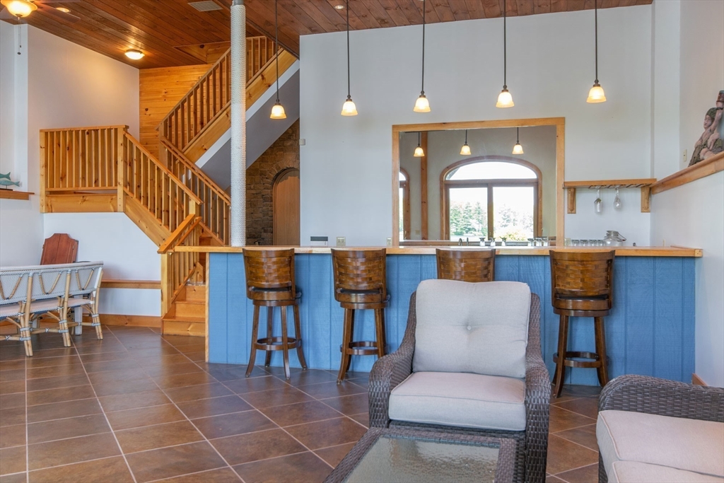 44 3rd Street Brimfield, MA 01010 - Photo 36 of 42 a living room with couches a dining table and chairs with wooden floor