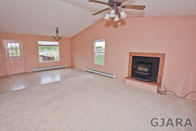 579 29 Road Grand Junction, CO 81501 - Photo 22 of 40 an empty room with windows and fireplace