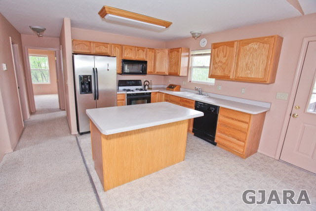 579 29 Road Grand Junction, CO 81501 - Photo 23 of 40 a kitchen with stainless steel appliances a refrigerator a sink a stove top oven a chimney and a center island