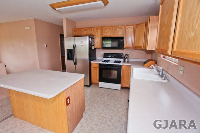 579 29 Road Grand Junction, CO 81501 - Photo 25 of 40 a kitchen with stainless steel appliances a stove a sink a microwave and a refrigerator