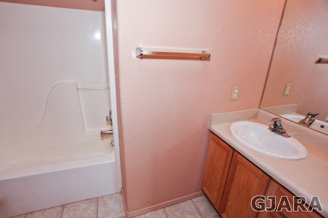 579 29 Road Grand Junction, CO 81501 - Photo 28 of 40 a bathroom with a sink a mirror and a bathtub