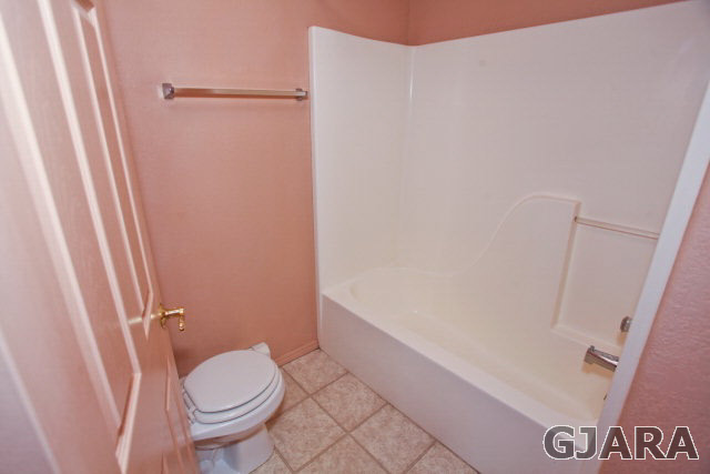 579 29 Road Grand Junction, CO 81501 - Photo 29 of 40 a bathroom with a granite countertop toilet and a sink