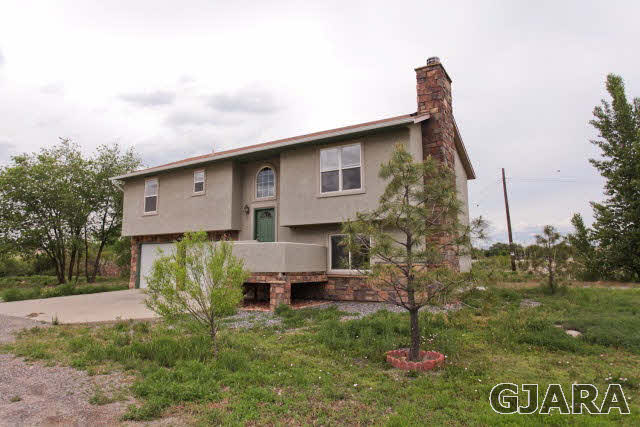 579 29 Road Grand Junction, CO 81501 - Photo 9 of 40 a front view of a house with a garden and pathway