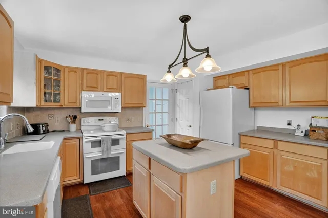 a kitchen with stainless steel appliances a sink stove and refrigerator