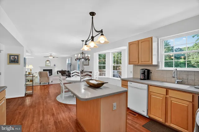 a kitchen with sink refrigerator and window