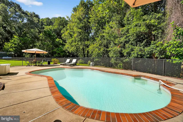 a view of a swimming pool with a patio