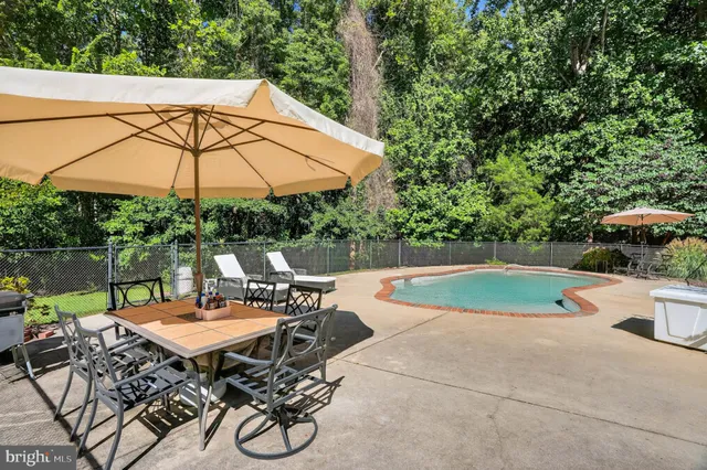 a view of backyard with seating space and trees