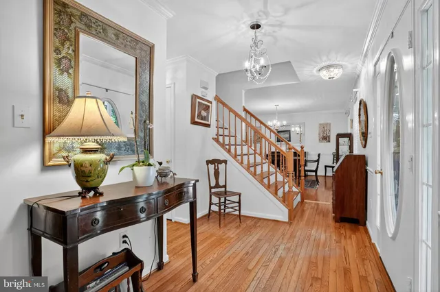 a view of entryway and hall with wooden floor