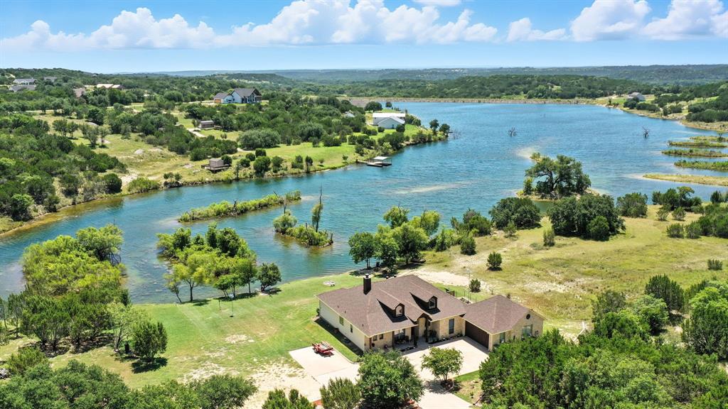 an aerial view of a houses with a lake view
