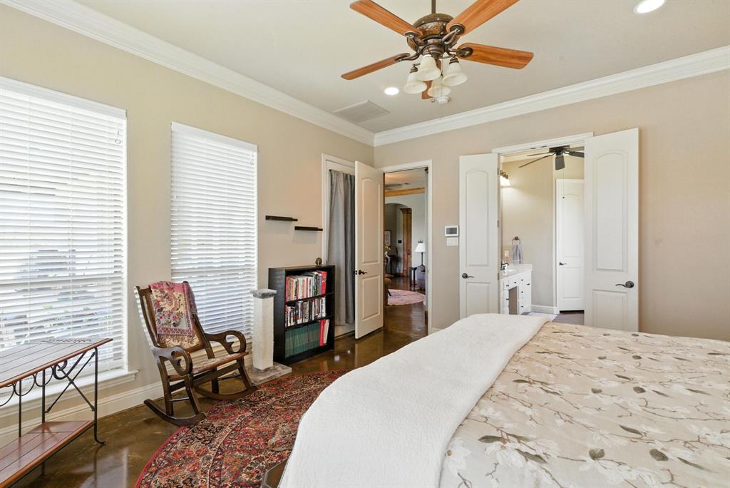 680 Sunfish Point Bluff Dale, TX 76433 - Photo 15 of 40 a bedroom with a large bed a chandelier and dresser