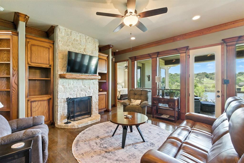680 Sunfish Point Bluff Dale, TX 76433 - Photo 10 of 40 a living room with furniture a fireplace and a flat screen tv