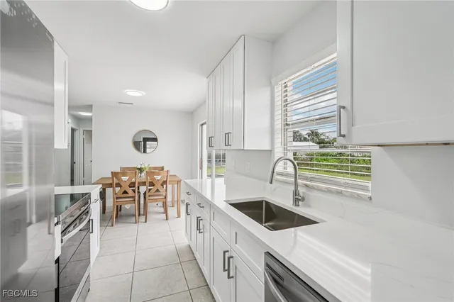 a kitchen with stainless steel appliances a sink a stove and a refrigerator