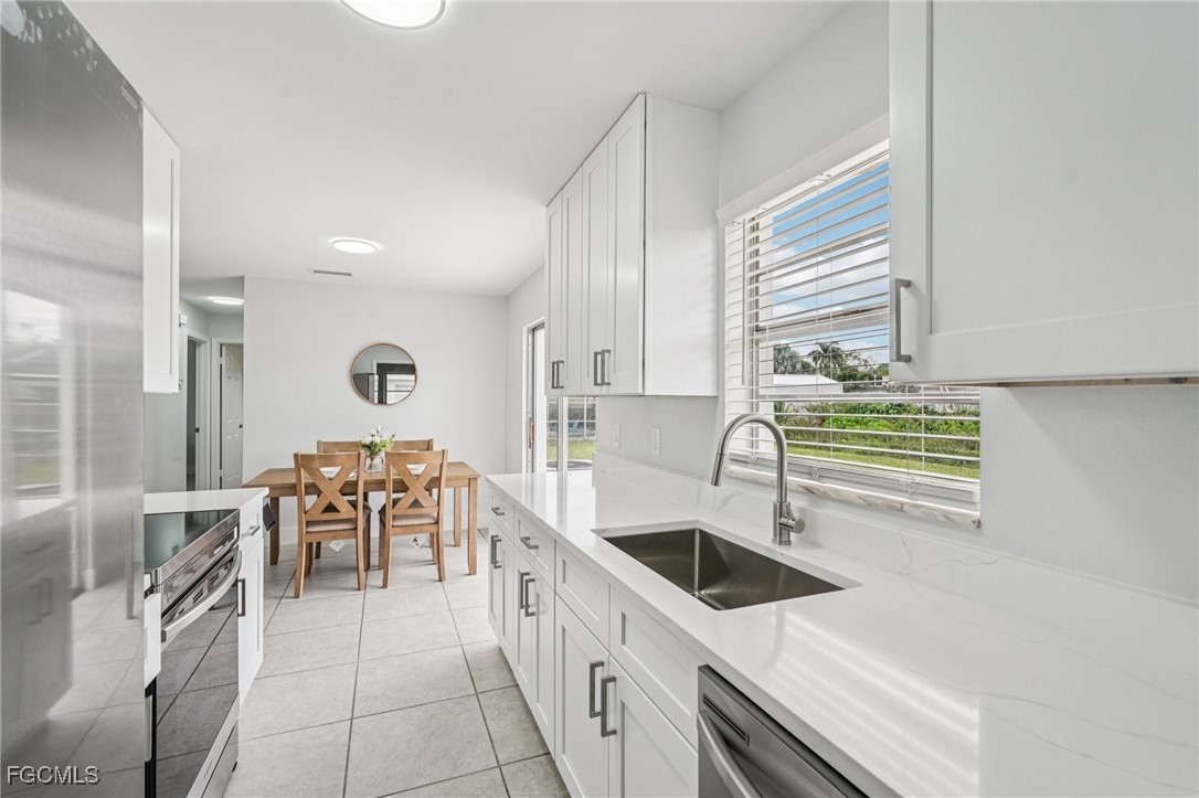 2342 Aldridge Avenue Fort Myers, FL 33907 - Photo 11 of 21 a kitchen with stainless steel appliances a sink a stove and a refrigerator