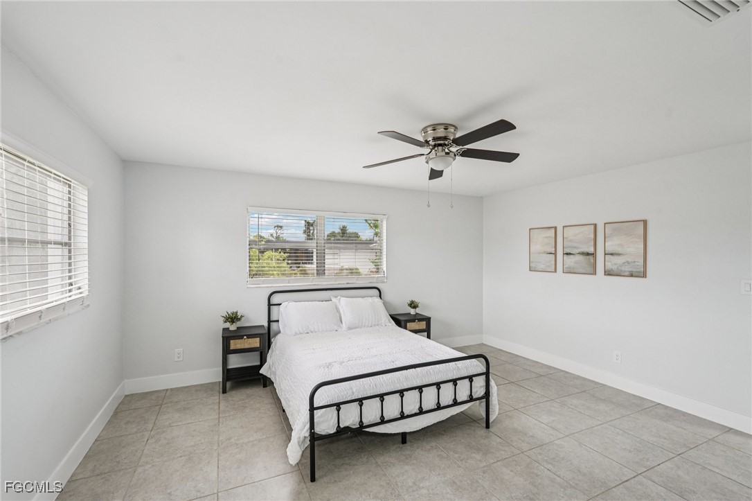 2342 Aldridge Avenue Fort Myers, FL 33907 - Photo 15 of 21 a bedroom with a bed and a ceiling fan