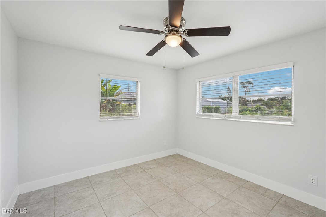 2342 Aldridge Avenue Fort Myers, FL 33907 - Photo 18 of 21 an empty room with windows and ceiling fan
