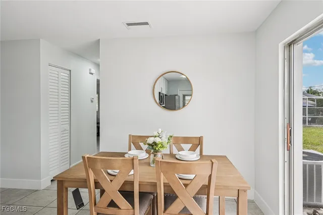 a view of a dining room with furniture and a mirror