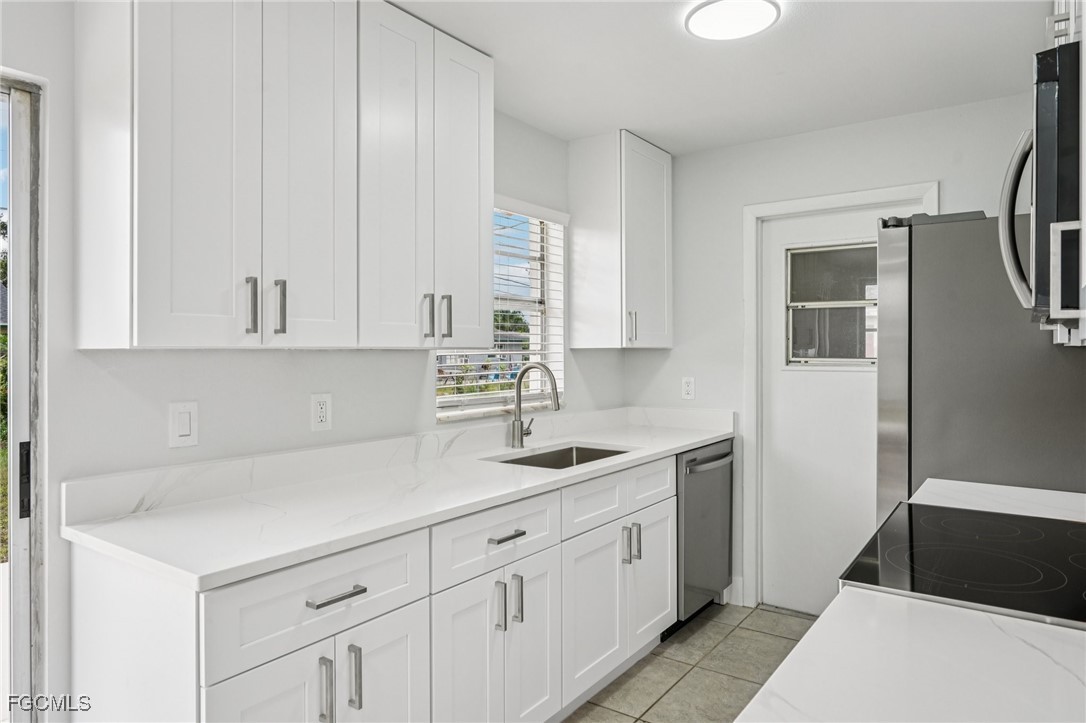 2342 Aldridge Avenue Fort Myers, FL 33907 - Photo 9 of 21 a kitchen with a sink and cabinets
