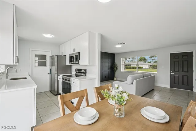 a dining room with furniture wooden floor and kitchen view