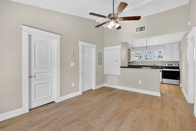 a view of a kitchen with a sink and cabinets