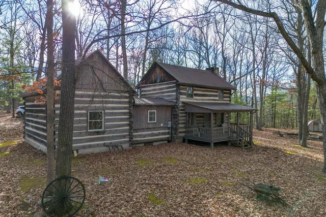 a view of a house with a yard and wooden fence