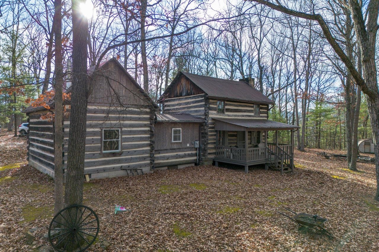 a view of a house with a yard and wooden fence