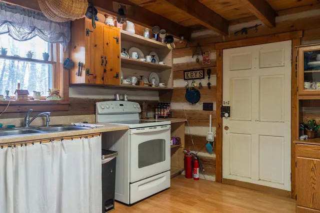 a dining room with furniture a chandelier and wooden floor