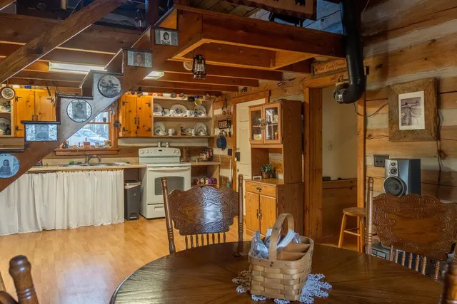a bedroom with a bed next to a window with the dresser